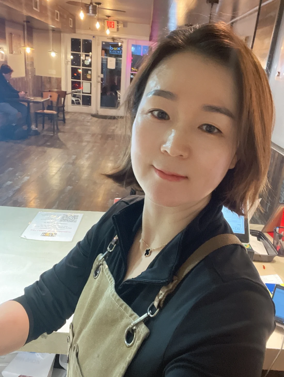 Nayoung Yum, owner of Box’d Kitchen, wearing her apron inside the restaurant