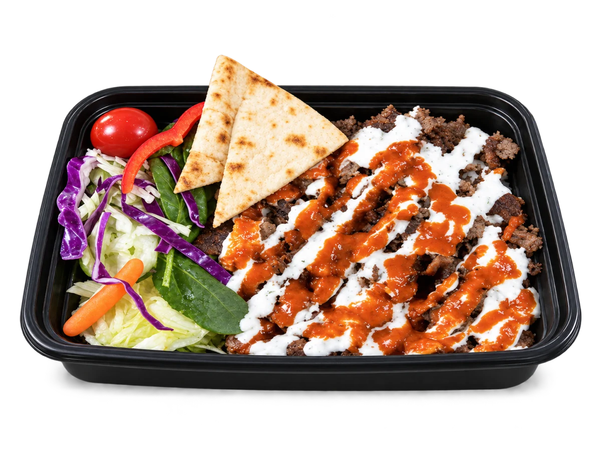 Thinly sliced rib-eye steak with white and red sauces, rice, salad and pita in a whole Box’d Kitchen takeaway tray